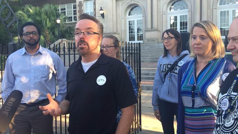 Pro-union teachers talk to reporters after losing an organizing fight in May.